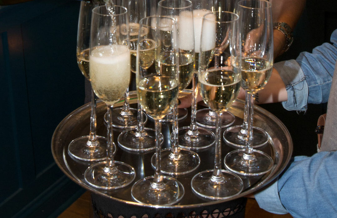 Sparkling wine being served to guests