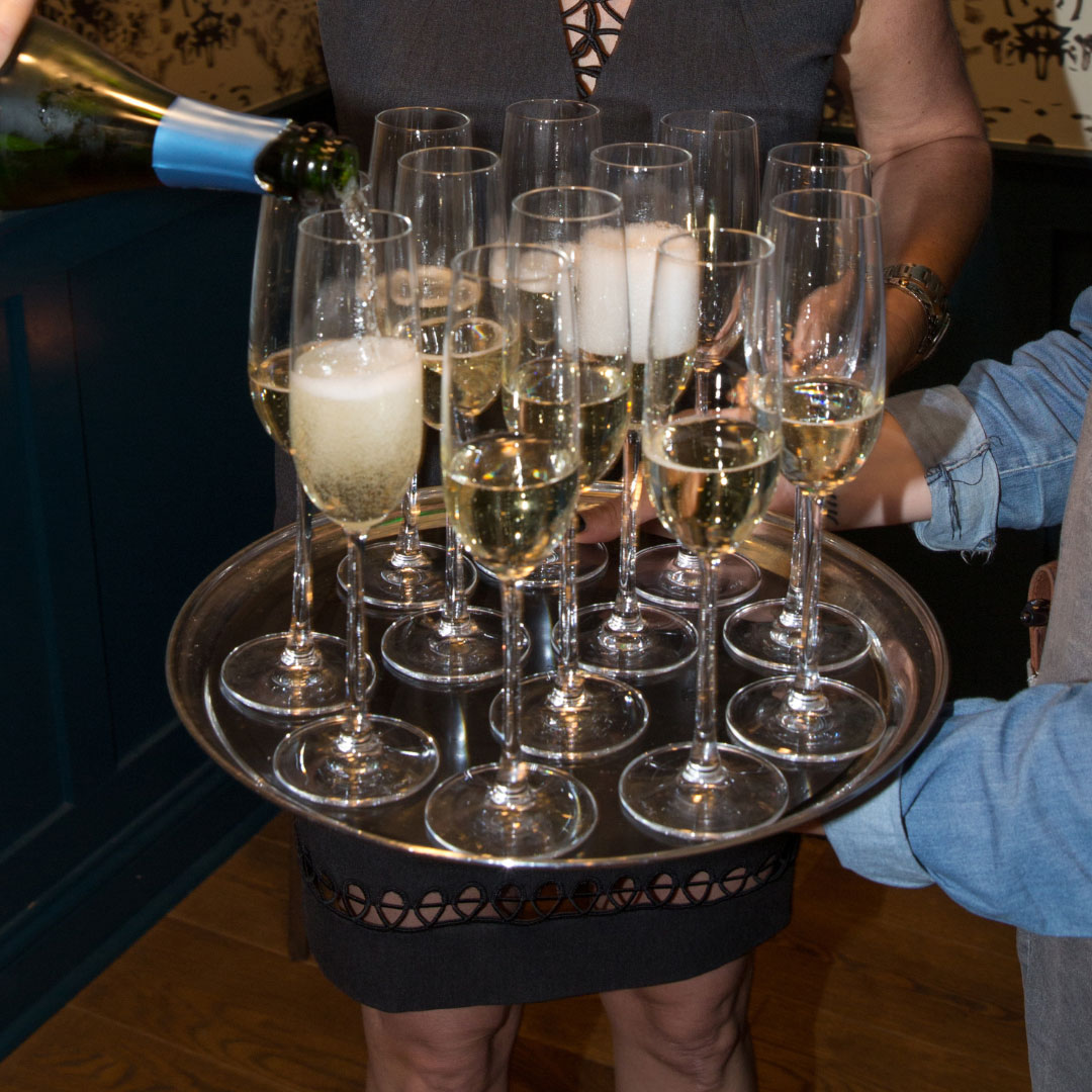 Sparkling wine being served to guests