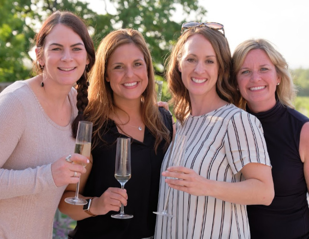 Four women smiling and drinking wine in Sonoma County
