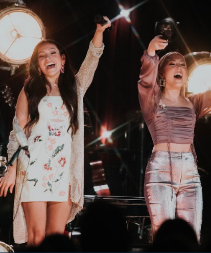 Maddie and Tae on stage, performing