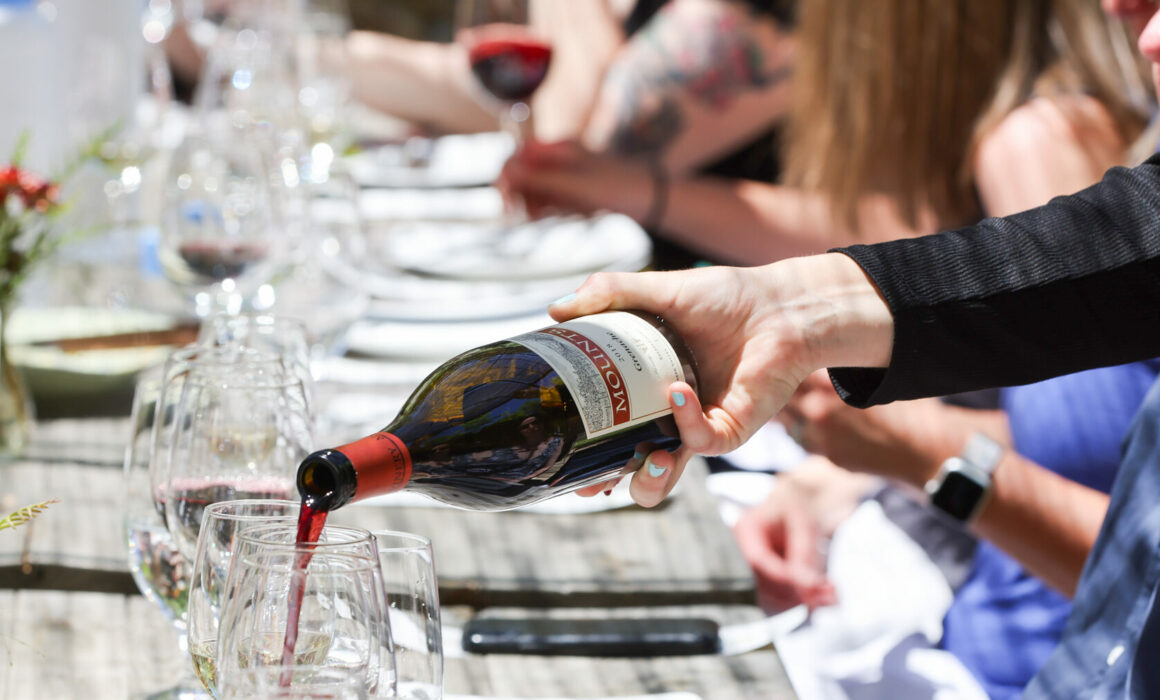 Wine being poured into a glass at an event