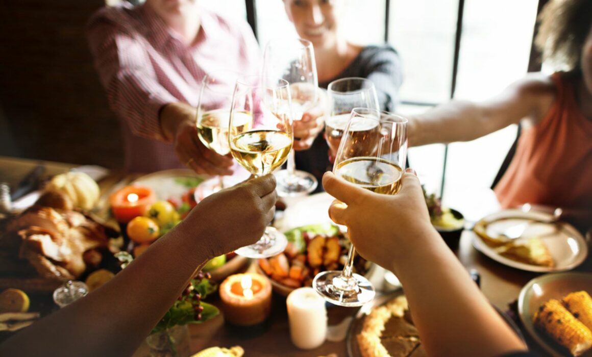 People toasting each other at a Thanksgiving table