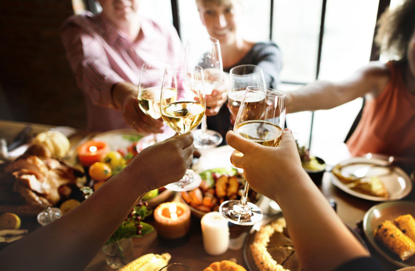 People toasting each other at a Thanksgiving table