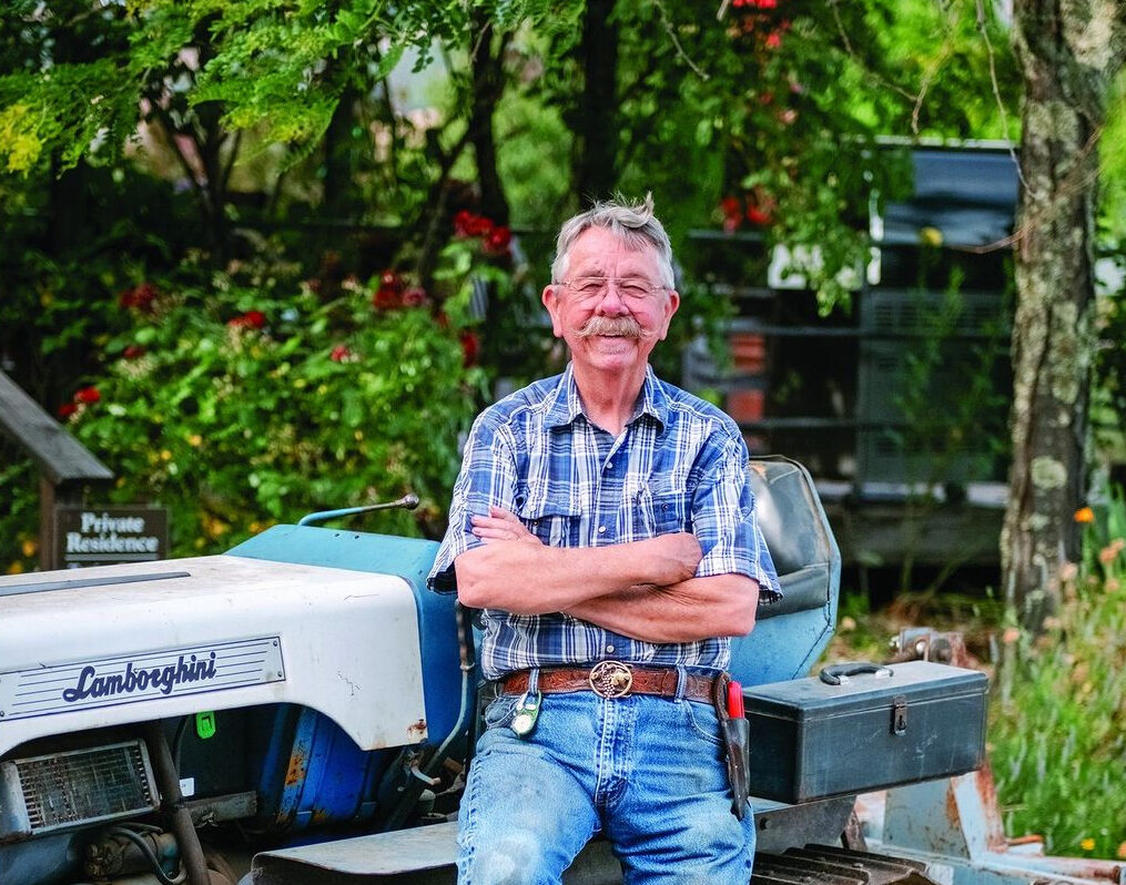 Photo of Grapegrower Jim Rickards on a large piece of farm equipment